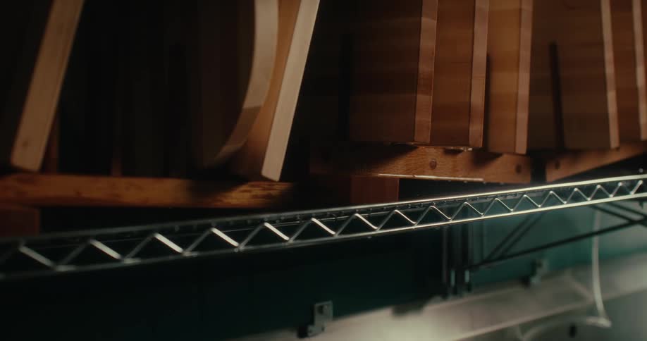 Pieces of wood on top of a shelf dripping drops of water as it dries
