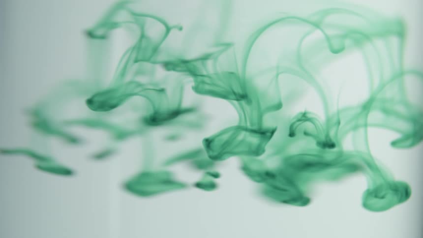 Dark green dye thins as it sinks through transparent liquid