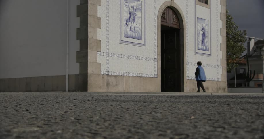 Facade of an artistic church with two people entering