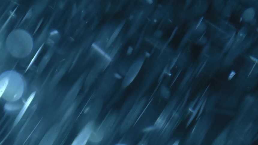 Abstract rotating moving water with particles