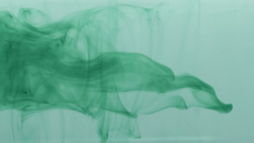 Liquid with greenish paint in abstract movement