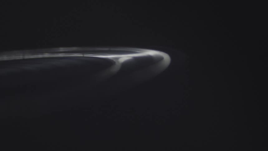 Spinning disk rotates through darkness