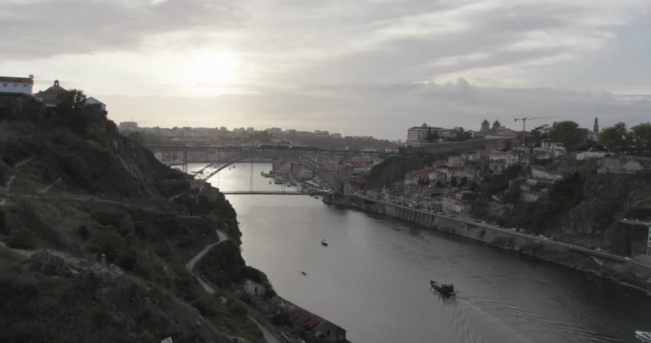 A sleepy city separated by a bridge as the sun rises