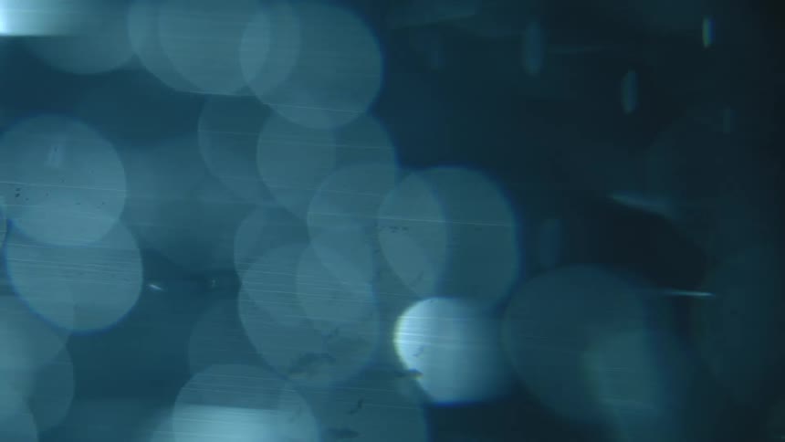 Extreme closeup of water with bubbles orbiting abstractly