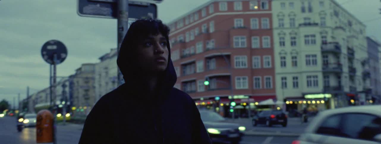 A boy walking on the busy street on 35mm Film