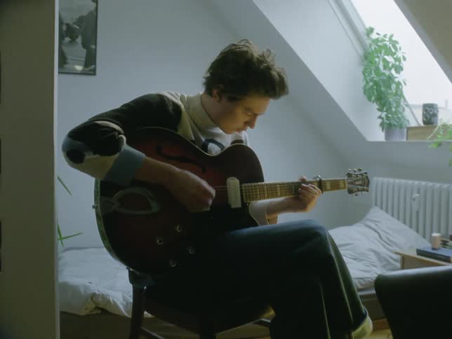 A clip of a person playing a guitar