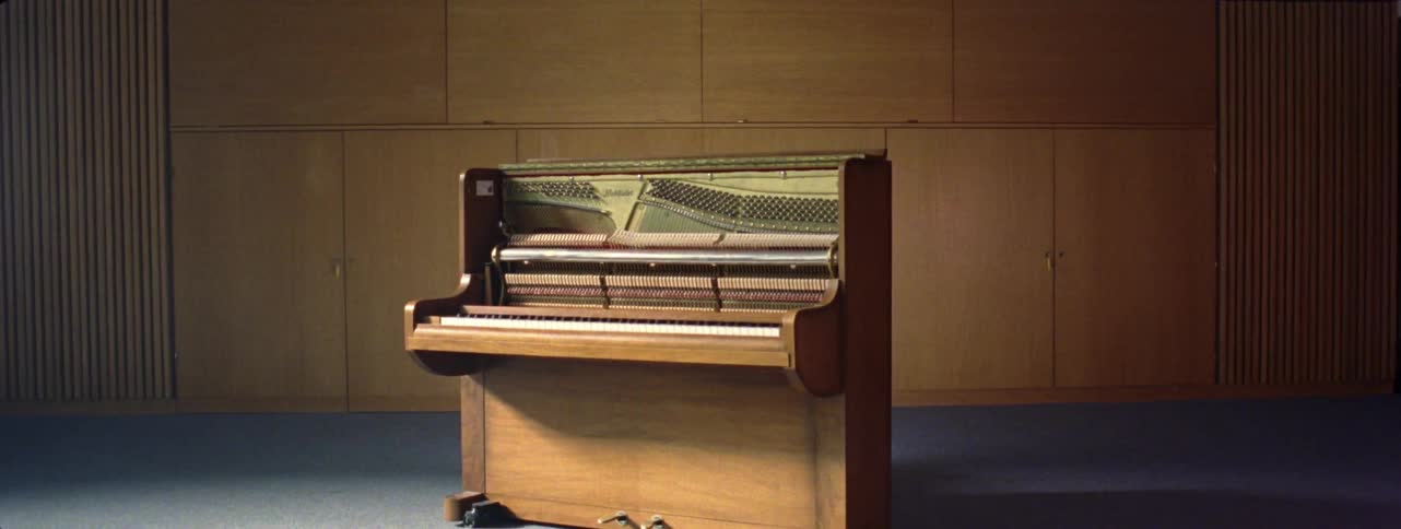 An orange light passing over an old organ piano