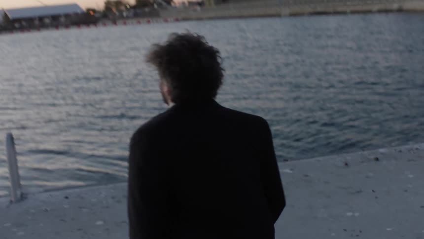 Back view of a man running on a dock one morning