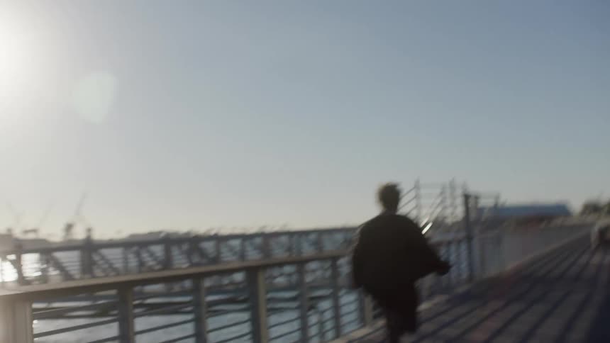 A man running on a boardwalk