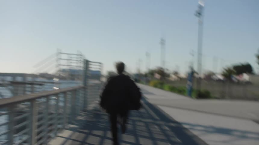 A man running on a boardwalk