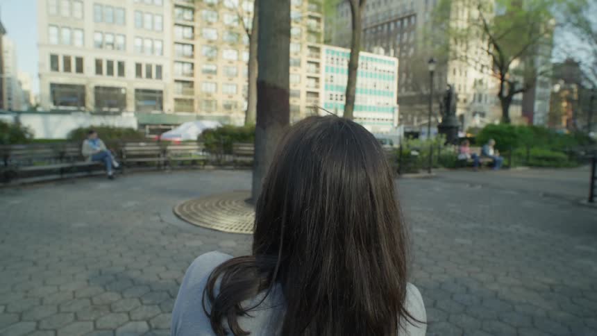 Point of view of a woman sitting drinking coffee and then getting up and walking across the square