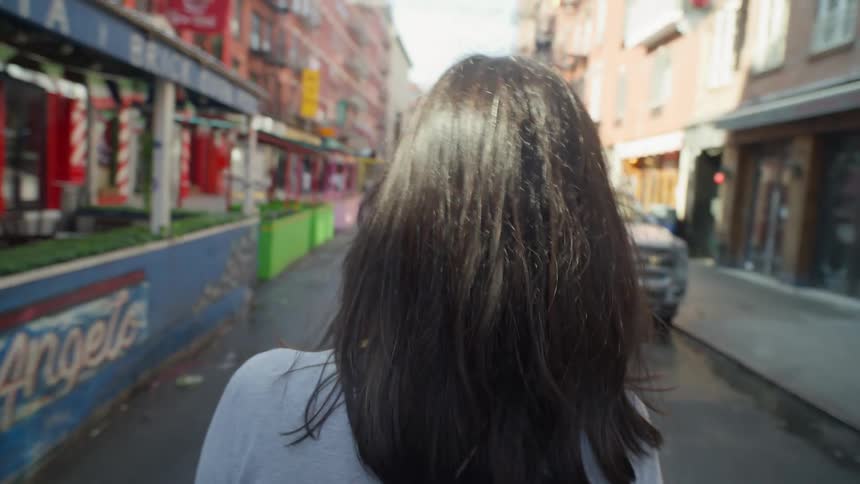 A woman crosses a street in NYC