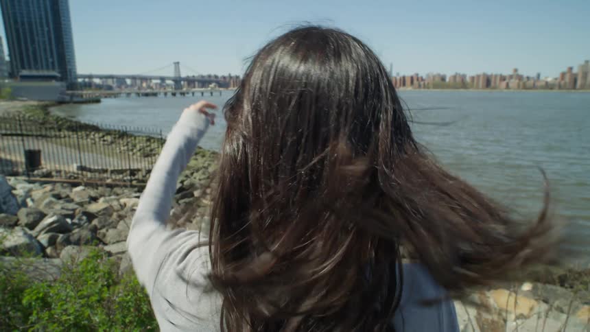 A tourist admiring the view of New York City across the water