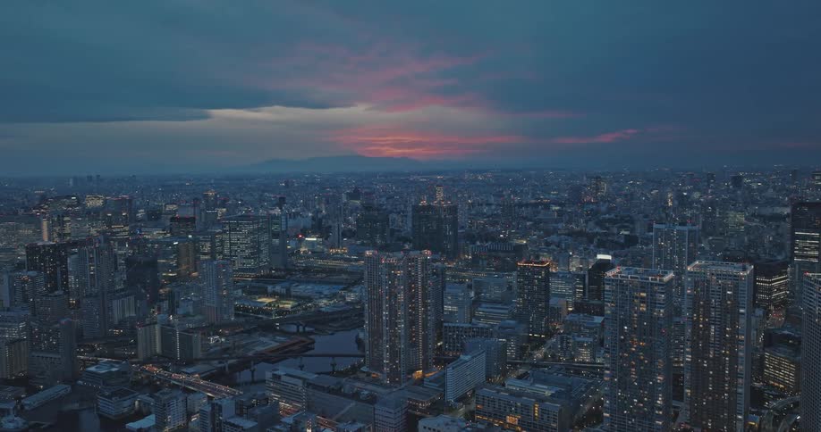 Aerial panorama of Tokyo skyscrapers illuminated at sunset
