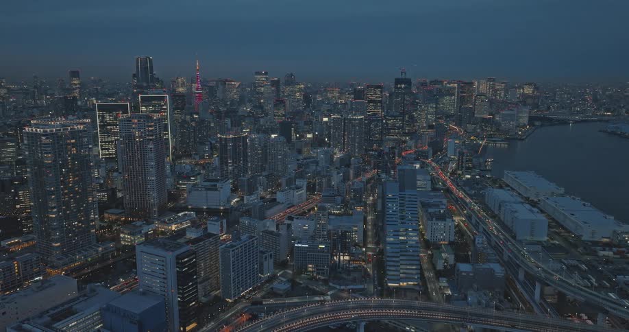 A night view of Tokyo, Minato City, and Tokyo Tower with tall buildings illuminated in many colors