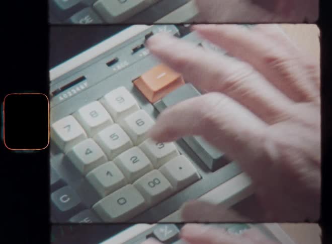 A dynamic Super-8 closeup shows a mans hand operating a cash register efficiently managing transactions with precision while the numbers or digits are displayed on the screen of the vintage digital calculator machine