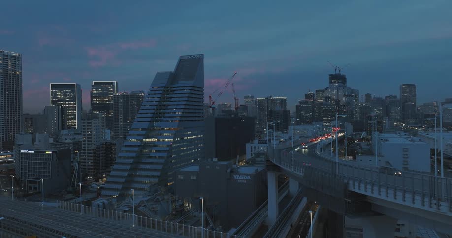 An aerial shot ascends to reveal the downtown Tokyo freeway