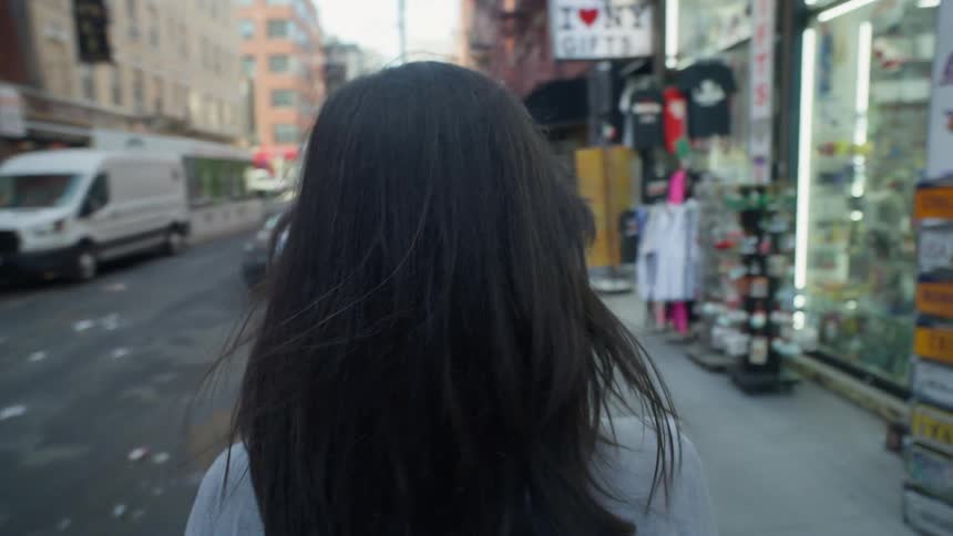 A woman walks down a city street