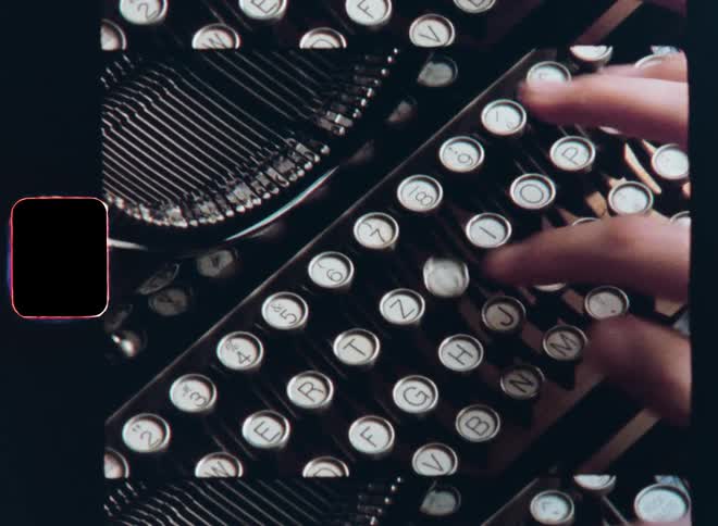 A closeup of a womans hands sitting at a wooden table as she types on a vintage typewriter machine with mechanical parts moving as her fingers precisely hit the keys of the vintage analogue writing device