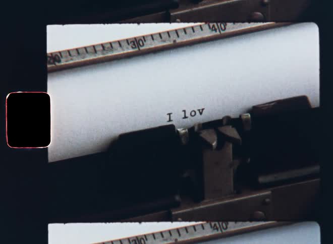 Vintage typewriter typing the words I love you with black ink on a sheet of white paper as the author or writer composes a love letter as a profession or declaration of love to his or her partner spouse husband wife or affair