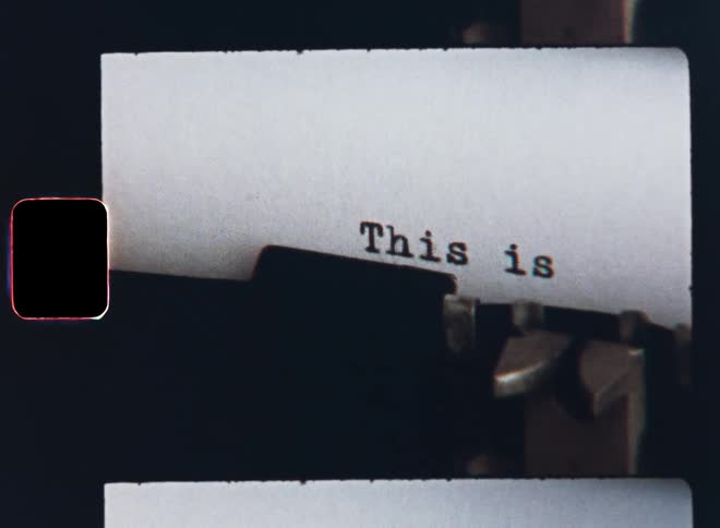 Super-8 closeup of the mechanical writing parts of an old typewriter machine typing the words or sentence This Is For You in a surprise letter as part of a Valentine’s Day gift or birthday present symbolizing old tech