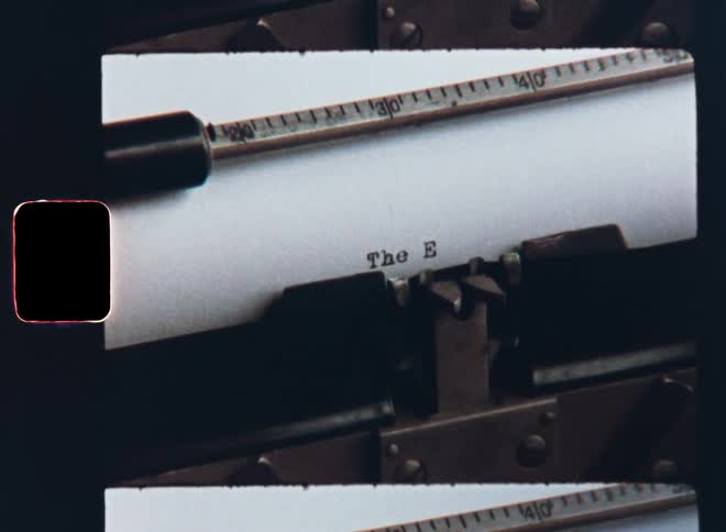 Dynamic Super 8mm close up film footage zooming in onto a vintage black and white typewriter that types or writes the words The End to make a dramatic ending of a story or letter or an end sequence