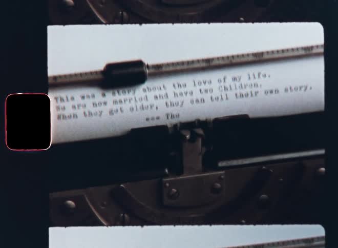 A generic love story about a couple and their children with a happy ending and the words The End being typed on a typewriter by an author or writer from last century caught on Super 8mm film footage with a nostalgic vibe