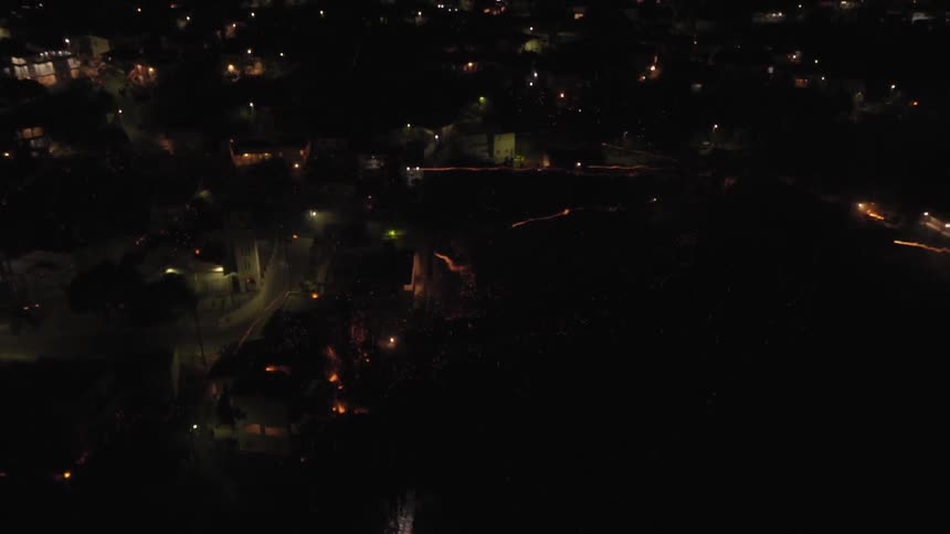 Fireworks are launched over a city at night