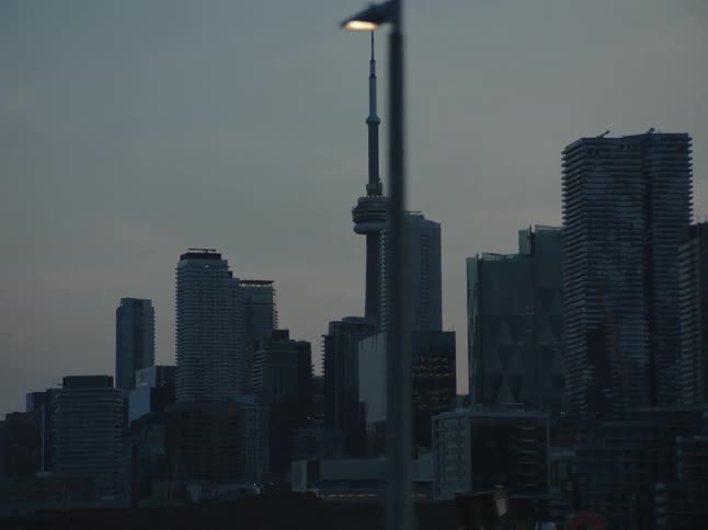 A tall tower looms over a downtown city area