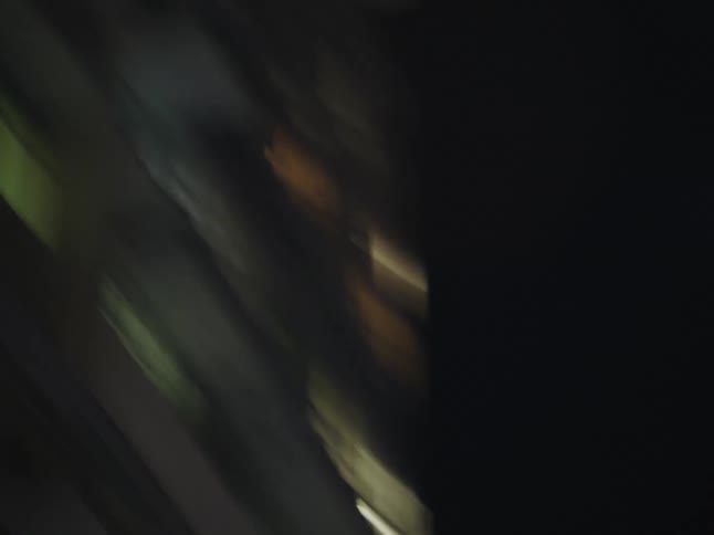 Light shines from skyscraper windows during the night