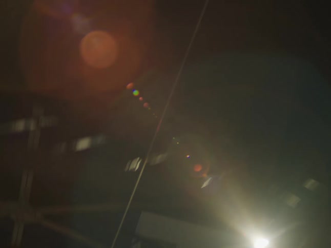 Upward view of a blurred building with night lighting