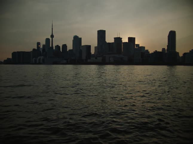 Calm sea and in the background the silhouette of a metropolis with skyscrapers