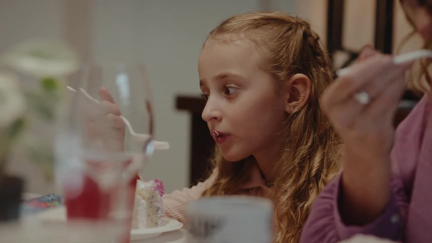 A child is eating cake at a birthday party