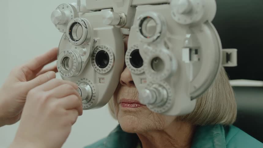 An elderly woman is having an eye exam
