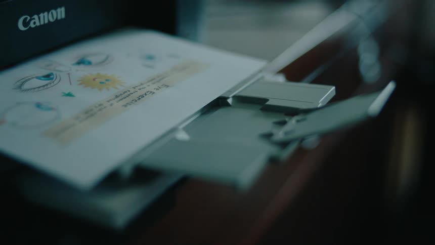 A printer kicks out a piece of paper