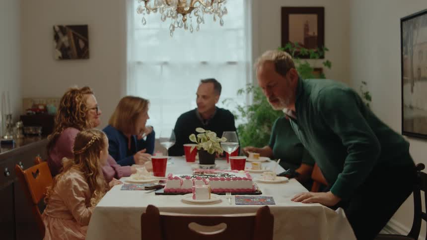 A family are having a birthday party with cake