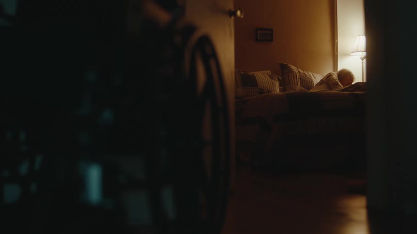 A woman turns her lamp off to go to bed