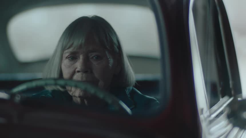 A woman looks sad while sitting in the car