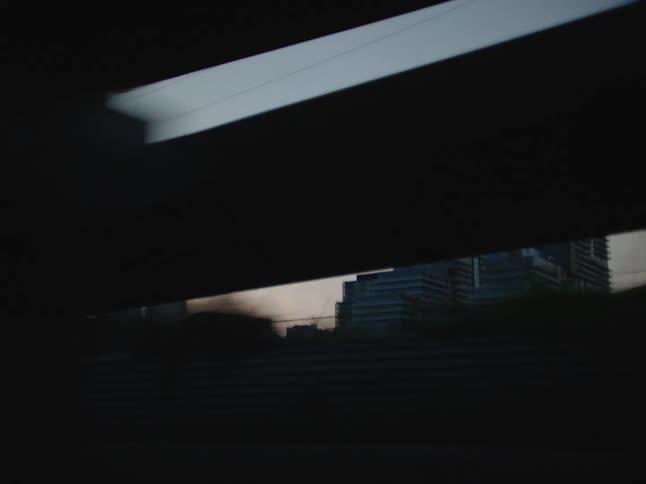 Past the overpass are tall buildings