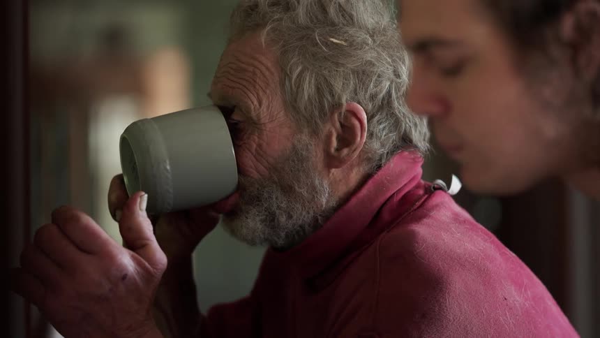 Father and son talking while eating breakfast at home