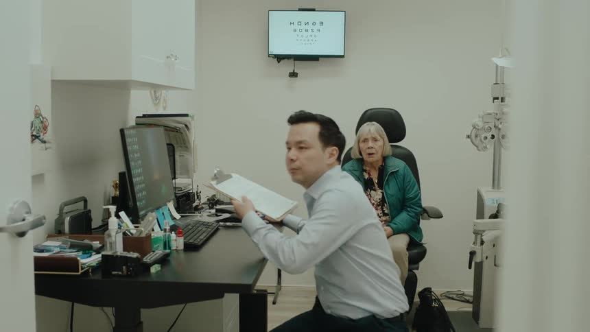 A concerned elderly patient follows a doctor out of his office