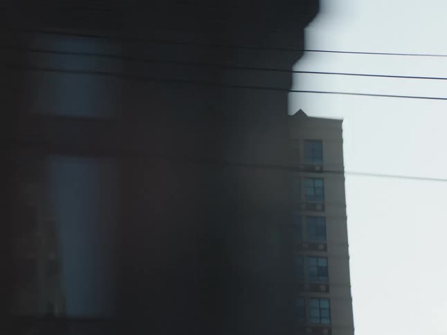 A vehicle speeds through the downtown area of the city surrounded by high rise buildings