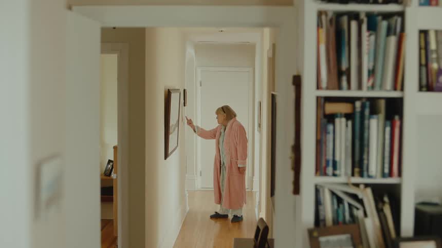 A woman walks in the hallway