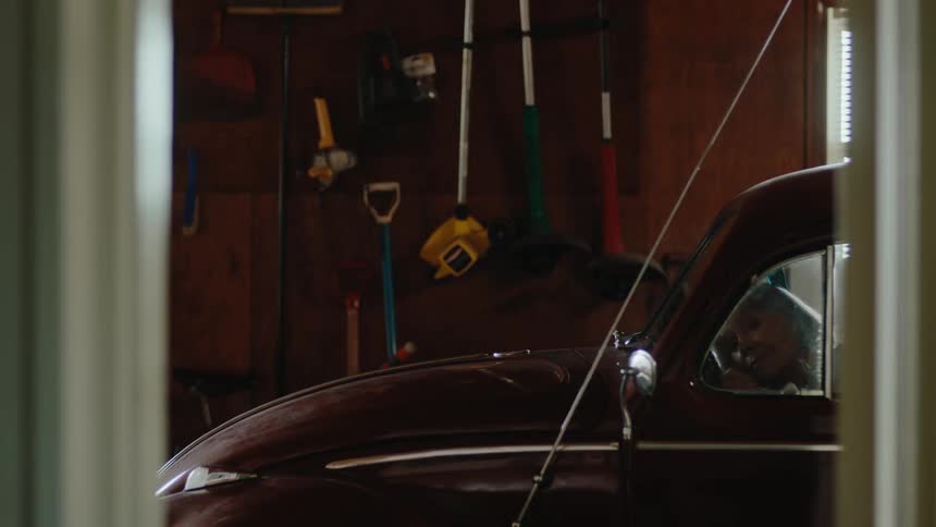 A clip of a blond lady in a beetle car