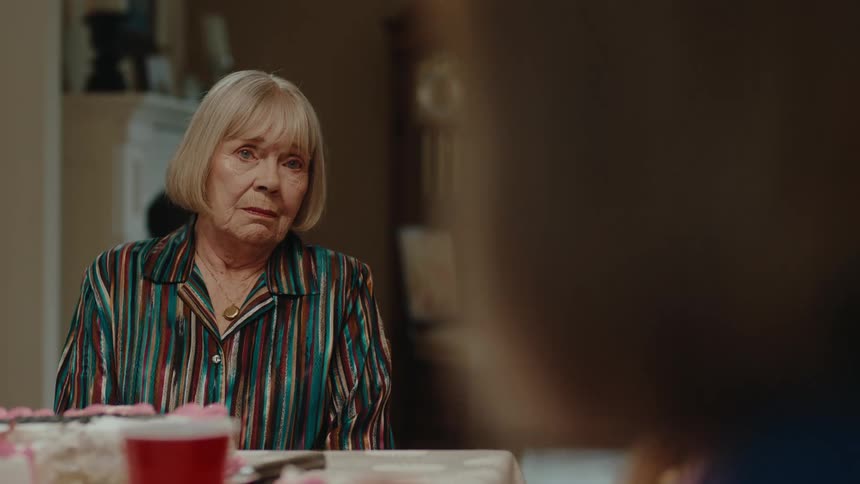 A woman gets annoyed and gets up from the table