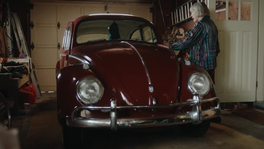 A woman walks over and touches her car