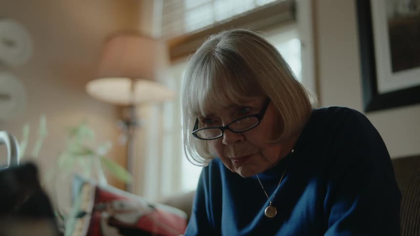 A woman writes with a pen