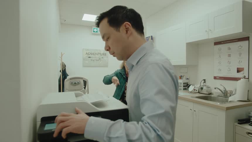 Elderly lady screaming and attacking a person at the printer