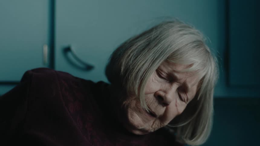 A woman sits up at home