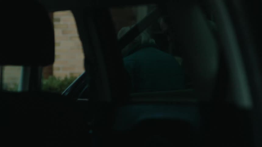 Elderly woman exits vehicle and is helped toward house entrance